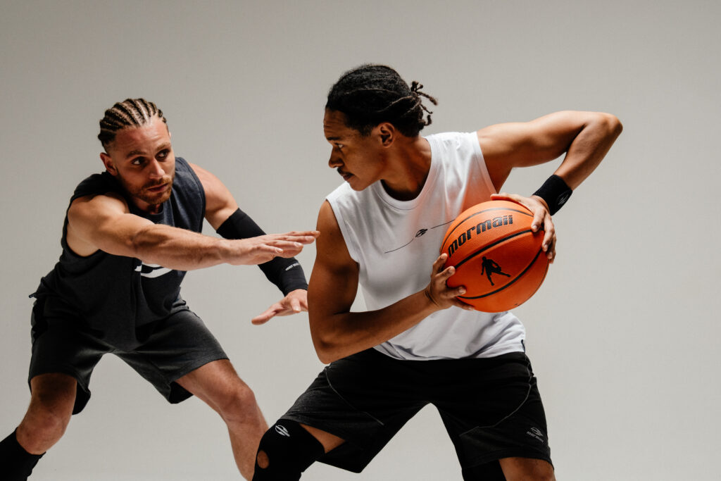 Two men playing bastketball showing discipline
